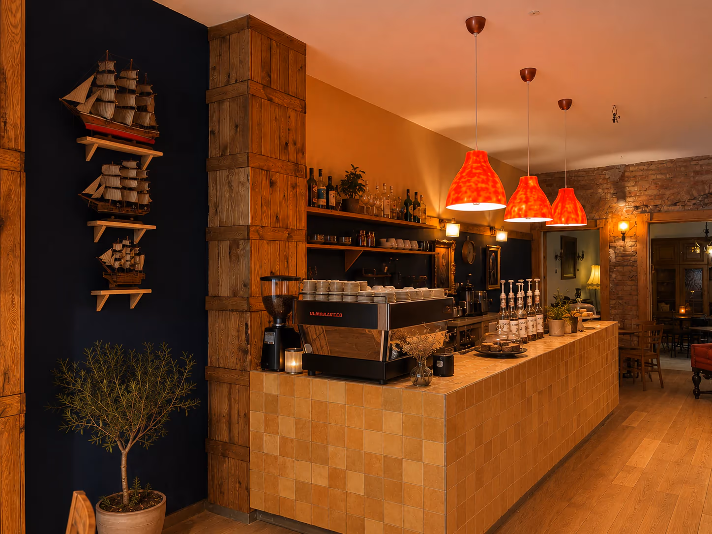 The warm wood, tiled counter and red pendant lights inside Judy’s Café.